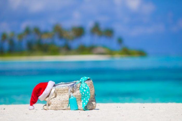 beach-accessories-with-santa-hat-on-white-tropical-2023-11-27-05-34-06-utc